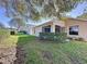 Landscaped backyard with lush grass and hedge at 3610 Rollingbrook St, Clermont, FL 34711