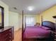 Bedroom with a post bed, dresser and sliding door to patio at 3610 Rollingbrook St, Clermont, FL 34711