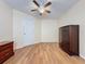 Spacious bedroom with wood-look floors and ceiling fan at 3610 Rollingbrook St, Clermont, FL 34711