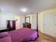 Well-lit bedroom with a post bed, dresser, and access to a bathroom at 3610 Rollingbrook St, Clermont, FL 34711