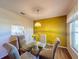 Bright dining area with yellow accent wall and glass table at 3610 Rollingbrook St, Clermont, FL 34711