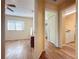 Bright hallway with wood-look floors, leading to bedrooms and bathroom at 3610 Rollingbrook St, Clermont, FL 34711