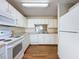 Bright kitchen with white cabinets, tile floor, and modern appliances at 3610 Rollingbrook St, Clermont, FL 34711