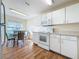 Kitchen with white cabinets, microwave, and a breakfast table at 3610 Rollingbrook St, Clermont, FL 34711