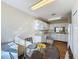 Open concept kitchen and dining area with wood floors at 3610 Rollingbrook St, Clermont, FL 34711