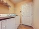 Laundry area with washer, dryer, and shelving at 3610 Rollingbrook St, Clermont, FL 34711