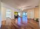 Open living room with wood floors, kitchen view, and patio access at 3610 Rollingbrook St, Clermont, FL 34711