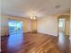 Spacious living room with wood floors, sliding door to patio, and ceiling fan at 3610 Rollingbrook St, Clermont, FL 34711