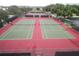 Community tennis courts with red and green surface at 3610 Rollingbrook St, Clermont, FL 34711