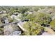 Aerial perspective of a tree-lined neighborhood with houses at 3817 Doune Way, Clermont, FL 34711