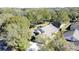 Aerial view of a house nestled in a wooded neighborhood at 3817 Doune Way, Clermont, FL 34711