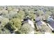 Aerial view of a residential neighborhood with lush trees and homes at 3817 Doune Way, Clermont, FL 34711