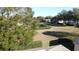 View of a backyard with a large grassy area and hedges at 3817 Doune Way, Clermont, FL 34711