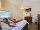 King-size bed, dresser, and large TV in this main bedroom at 3817 Doune Way, Clermont, FL 34711