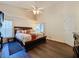 Main bedroom with king bed, dark wood furniture, and dark flooring at 3817 Doune Way, Clermont, FL 34711