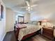 Bright bedroom with a wooden bed frame and dark wood flooring at 3817 Doune Way, Clermont, FL 34711