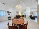 Spacious dining area with a round wooden table and chairs, offering a view of the living room at 3817 Doune Way, Clermont, FL 34711