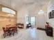 Light and airy entryway with tile floors, a bench, and a view of the living and dining areas at 3817 Doune Way, Clermont, FL 34711