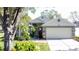 House exterior featuring a two-car garage and well-manicured lawn at 3817 Doune Way, Clermont, FL 34711