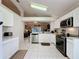 Spacious kitchen with ample counter space, stainless steel appliances, and view to Gathering room at 3817 Doune Way, Clermont, FL 34711