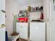 Functional laundry room with washer, dryer, and ample shelving at 3817 Doune Way, Clermont, FL 34711
