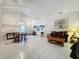 Bright and airy living room with tile floors, ample natural light, and a dining area at 3817 Doune Way, Clermont, FL 34711