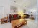 Living room features a brown couch, large mirror, and wooden coffee table at 3817 Doune Way, Clermont, FL 34711