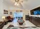 Living Room with leather couches and a large TV at 3817 Doune Way, Clermont, FL 34711