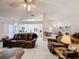 Open living room with leather furniture, high ceilings, and a view of the kitchen at 3817 Doune Way, Clermont, FL 34711