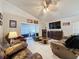 Spacious living room with leather furniture and a view of the lanai at 3817 Doune Way, Clermont, FL 34711