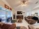 Living room with access to lanai and a large TV at 3817 Doune Way, Clermont, FL 34711