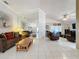 Open concept living room with leather furniture, high ceilings, and lots of natural light at 3817 Doune Way, Clermont, FL 34711