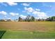 Spacious backyard with grassy area and screened enclosure at 3839 Manor Oaks Ct, Leesburg, FL 34748