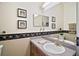 Bathroom with granite vanity and decorative border at 3839 Manor Oaks Ct, Leesburg, FL 34748