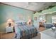 A charming bedroom with a light blue wall features a comfortable bed, two nightstands, and decor at 3839 Manor Oaks Ct, Leesburg, FL 34748