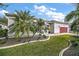 House exterior with landscaping and palm trees at 3839 Manor Oaks Ct, Leesburg, FL 34748