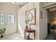 Inviting foyer with a decorative mirror, console table, and neutral carpet that is both stylish and functional at 3839 Manor Oaks Ct, Leesburg, FL 34748