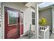 Dark-red front door with glass inserts and sidelights at 3839 Manor Oaks Ct, Leesburg, FL 34748