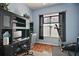 Home office features built-in shelving and a home gym at 3839 Manor Oaks Ct, Leesburg, FL 34748