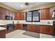 Kitchen with dark wood cabinets, marble countertops, and black appliances at 3839 Manor Oaks Ct, Leesburg, FL 34748