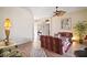 Living room with floral couches, ceiling fan, and hardwood floors at 3839 Manor Oaks Ct, Leesburg, FL 34748