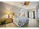 Main bedroom with a king-size bed and plenty of natural light at 3839 Manor Oaks Ct, Leesburg, FL 34748