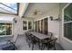 This covered patio includes an outdoor dining and an adjacent living space with a pool at 3839 Manor Oaks Ct, Leesburg, FL 34748