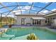 Relaxing screened-in pool area with lush landscaping and ample seating for enjoying the outdoors at 3839 Manor Oaks Ct, Leesburg, FL 34748