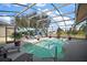 Screened pool with waterfall mural and lounge chairs at 3839 Manor Oaks Ct, Leesburg, FL 34748