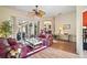 Sunroom with floral couches and access to a patio at 3839 Manor Oaks Ct, Leesburg, FL 34748