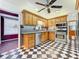 Bright kitchen with oak cabinets, granite counters, stainless steel appliances and checkerboard floor at 407 Park Ln, Eustis, FL 32726