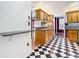 View of kitchen with wood cabinets and black and white checkered floor at 407 Park Ln, Eustis, FL 32726