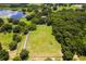 Aerial view of property showing home, fenced pasture, and lake at 43140 Hossin Around Ln, Altoona, FL 32702