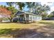 House exterior boasts a charming front porch and well-manicured lawn at 43140 Hossin Around Ln, Altoona, FL 32702